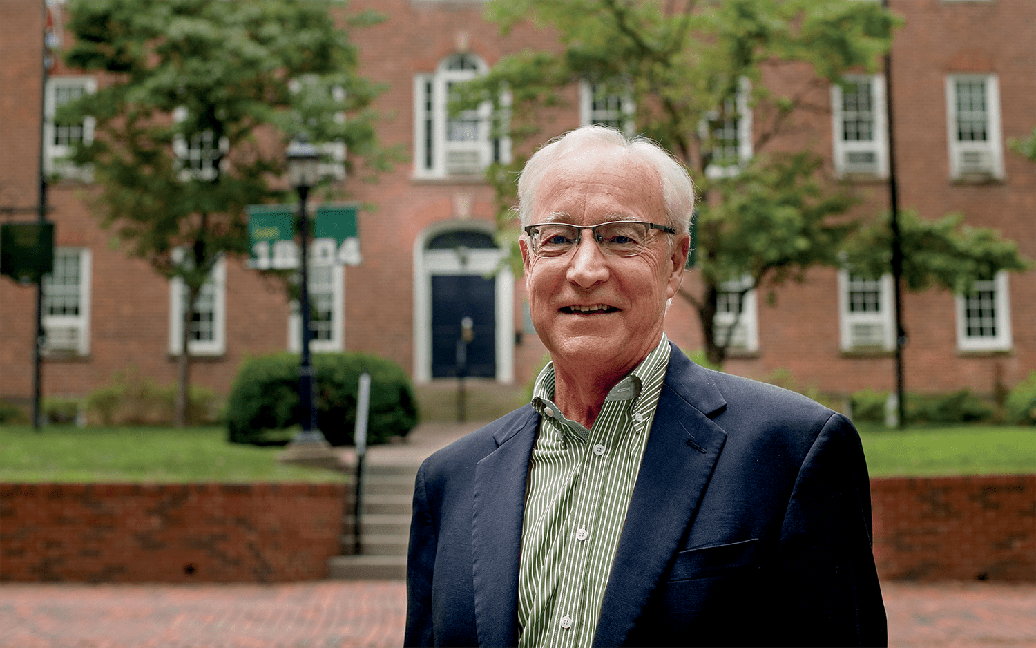 President Sherman posing with Cutler Hall behind him