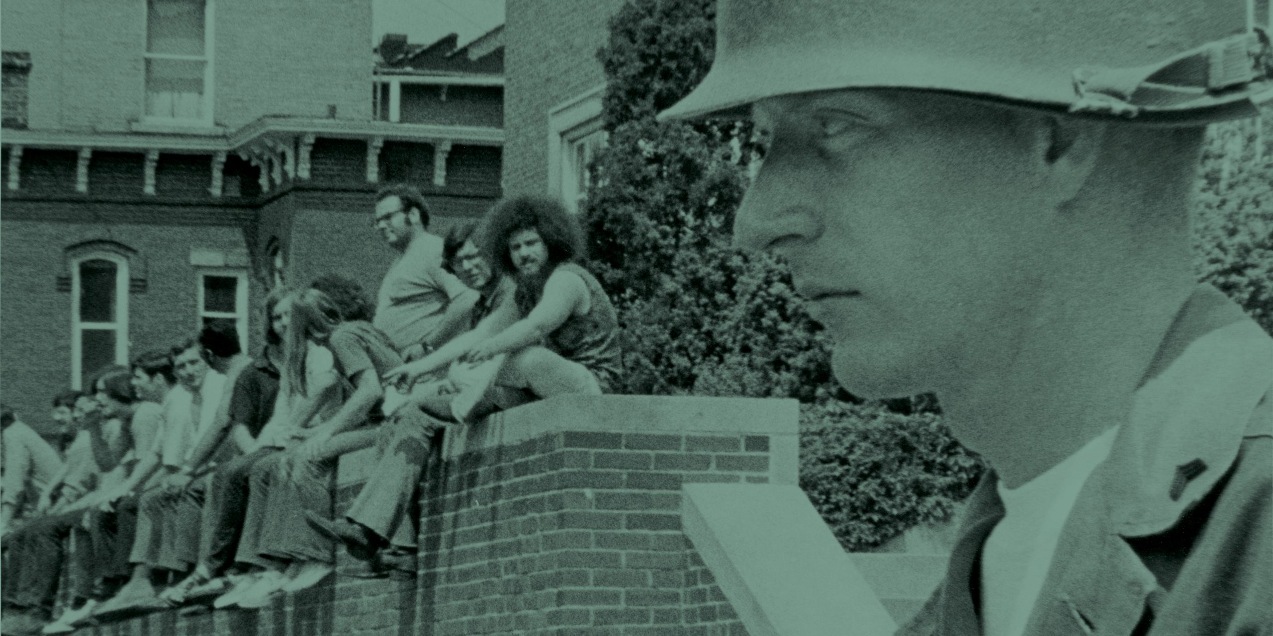 Students sitting a wall with soldier in the foreground