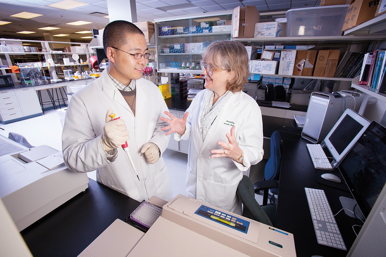 Jennifer Hines working in lab with team member