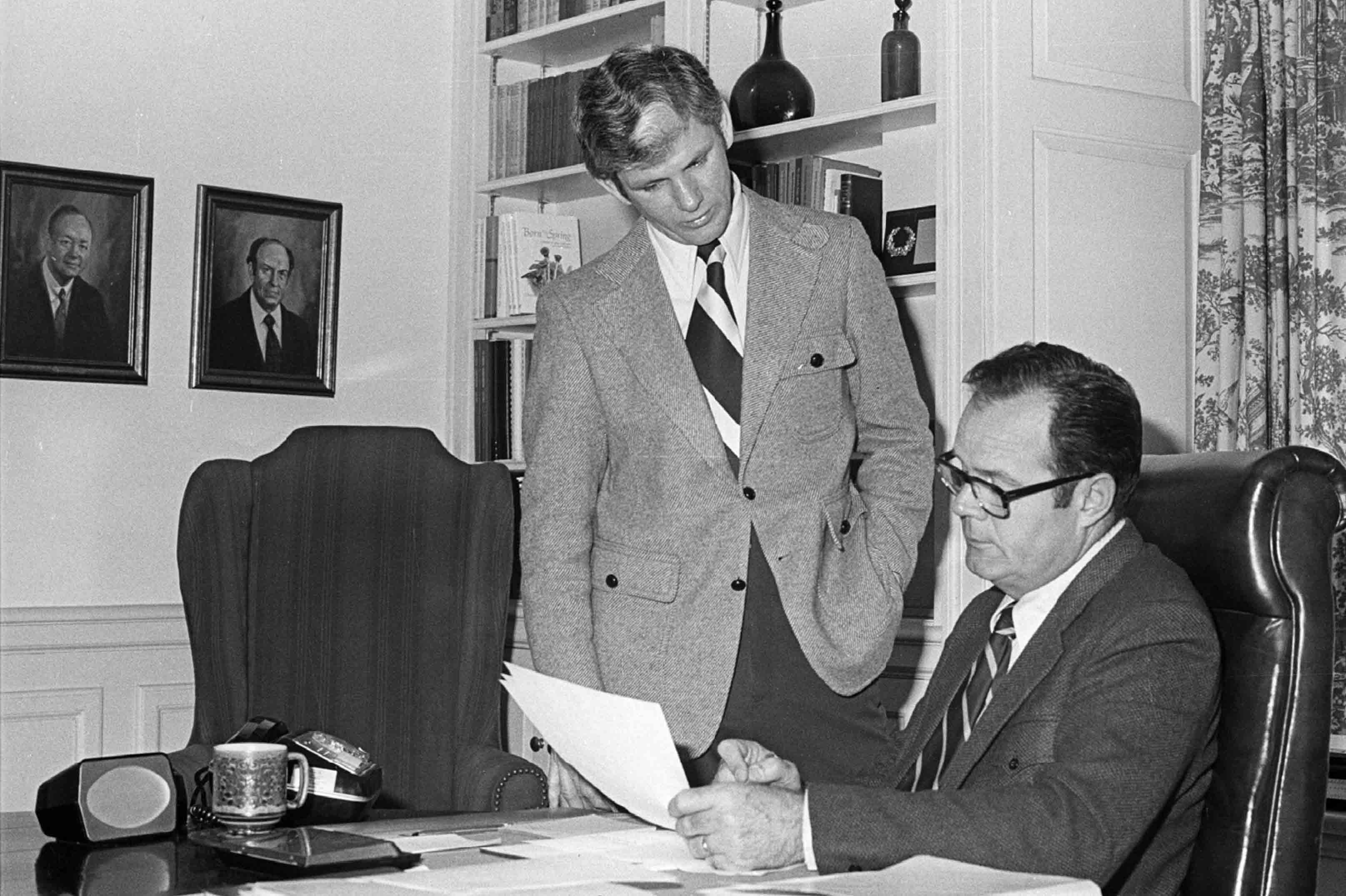 President Ping looks at a document with a colleague in a University office