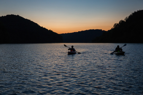 People kayak during sunset in Athens, Ohio