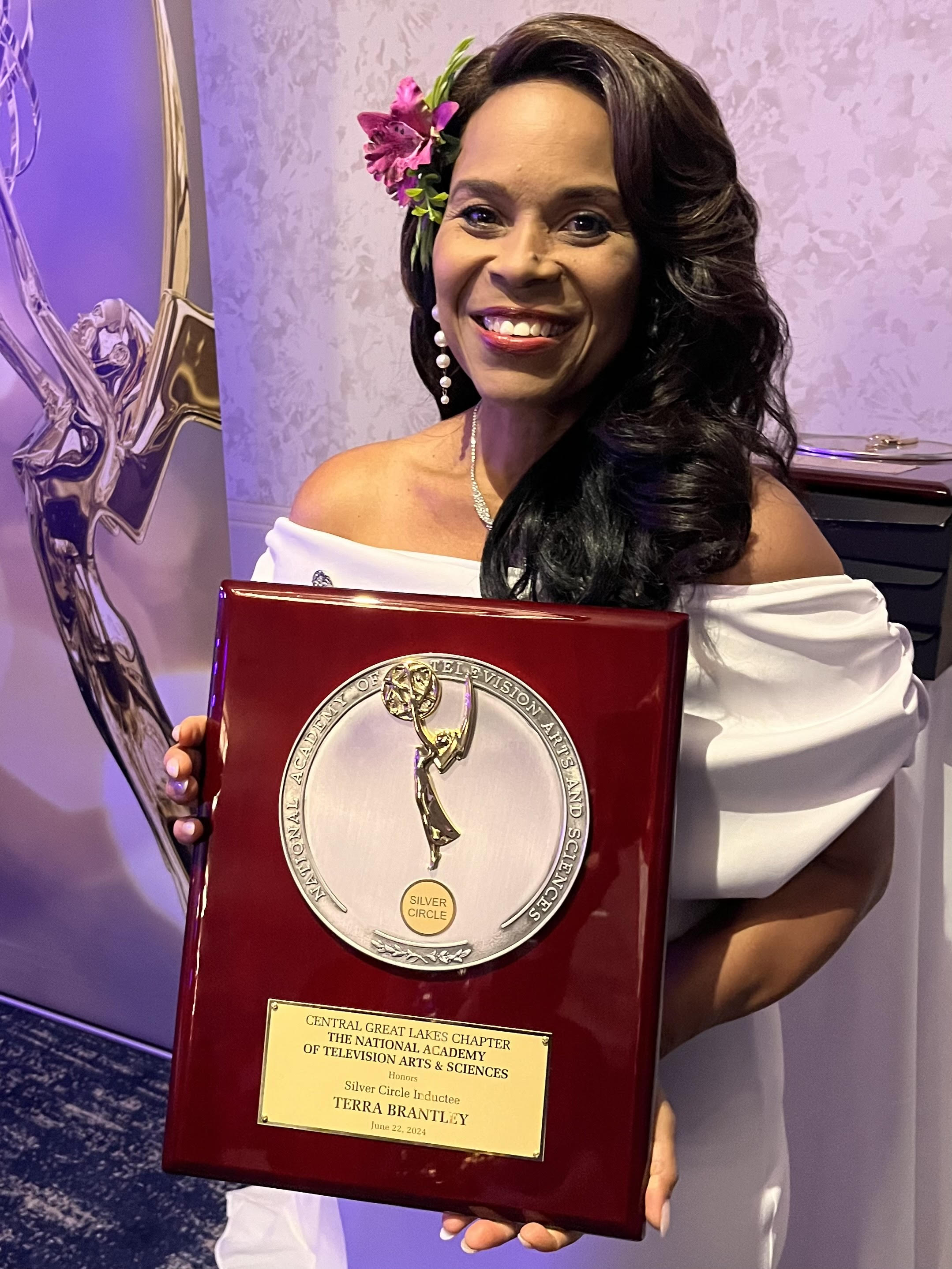 Ohio University alumna Terra Brantley holding her Silver Circle Lifetime Achievement Emmy