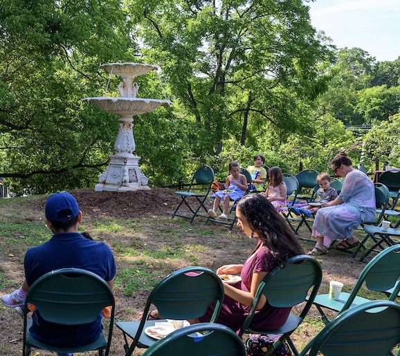 Families sit around listening to musicians play