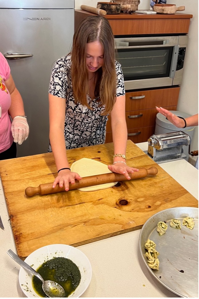 a woman rolls dough with a rolling pin