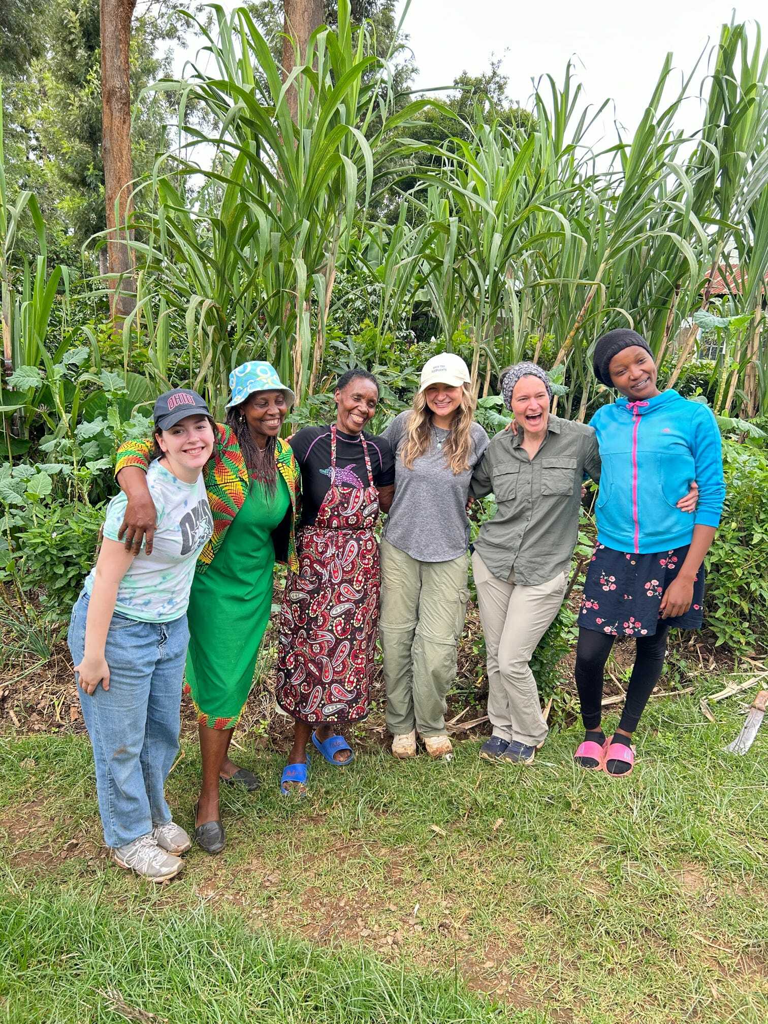 Geography student poses for photo with members of their internship