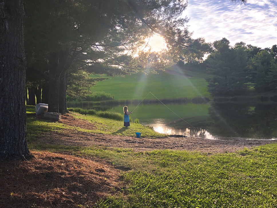 Young girl fishing on a pond in Appalachia