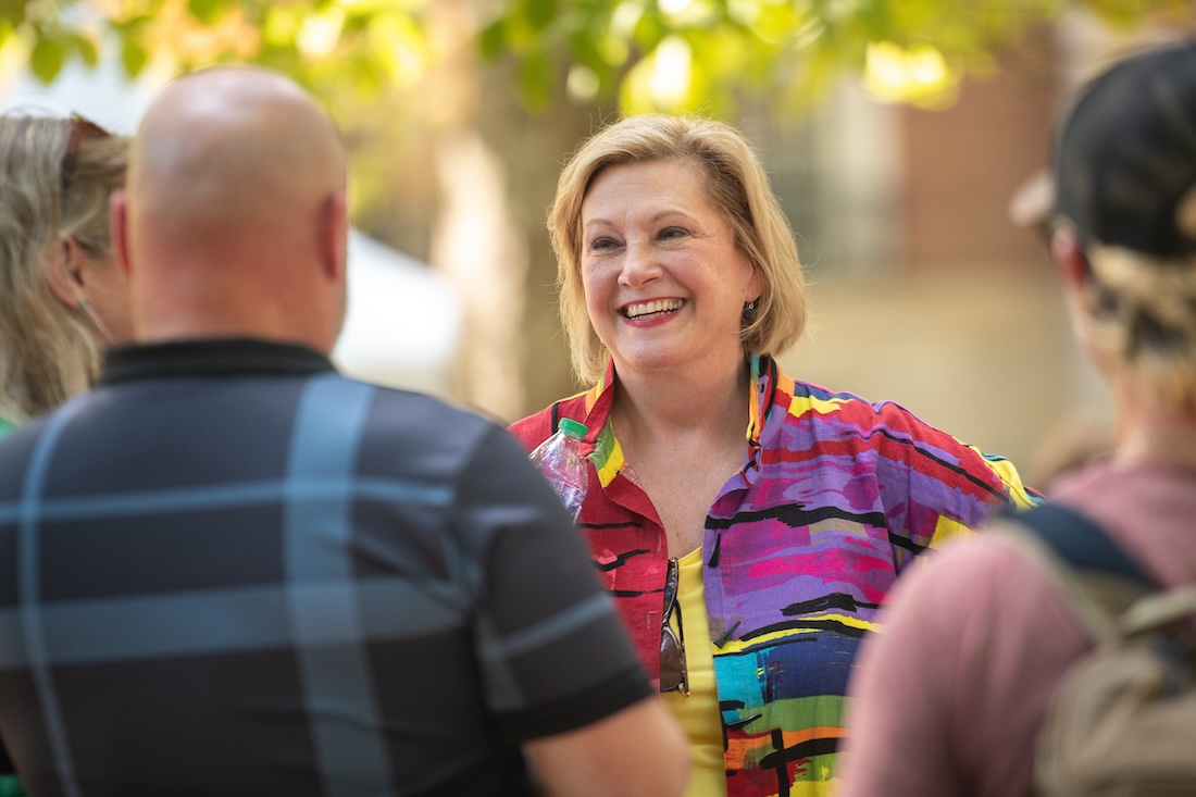 President Gonzalez smiles as she speaks to a group