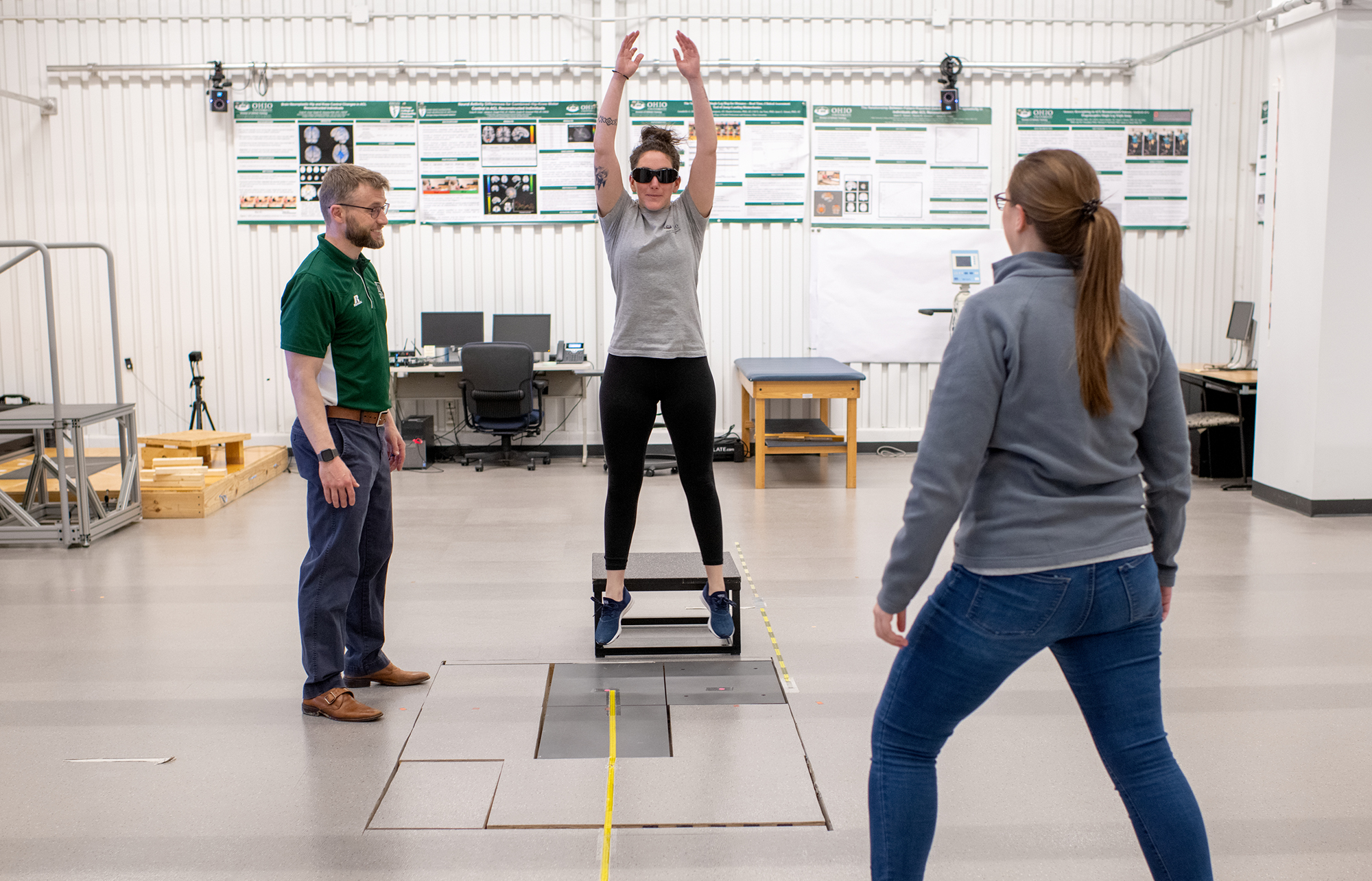 researchers in street clothes conduct a movement experiment