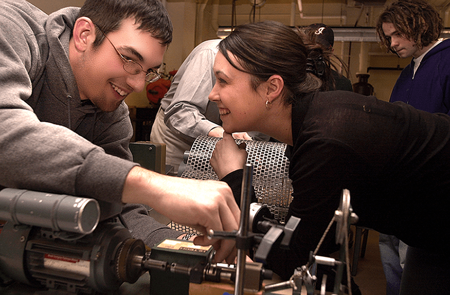 An Ohio University engineering student observes an employee of Sunpower on location at the factory