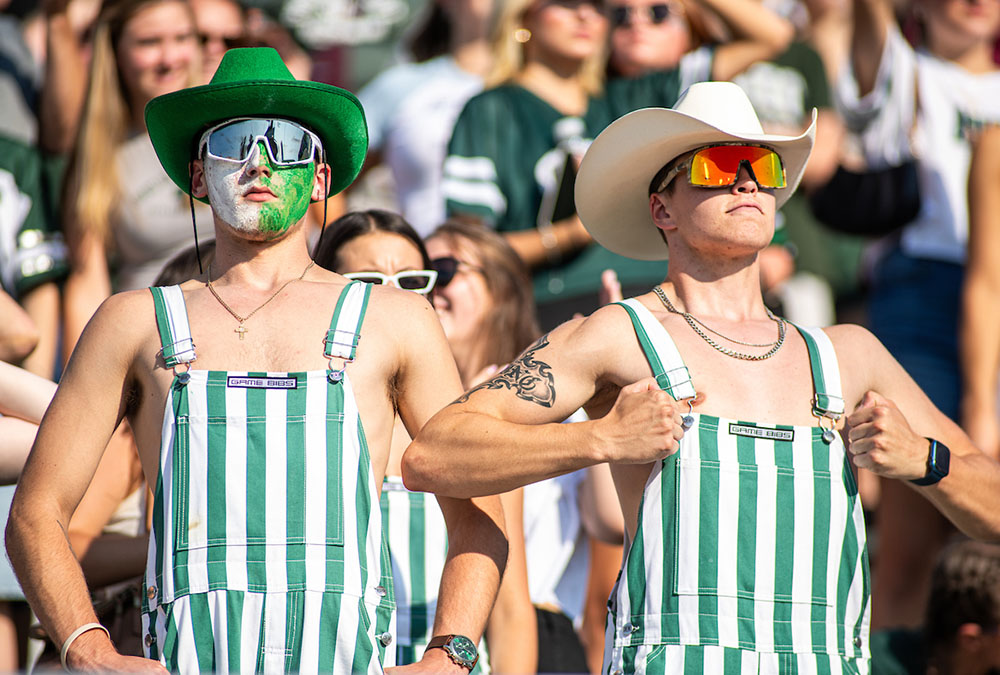 Decked out in true Bobcat style, fans come from all over to show their pride and cheer on the team. From cowboy hats to pinstriped overalls, there’s no mistaking their love for OHIO.