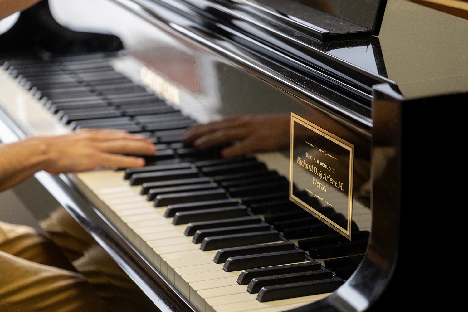 An OHIO student plays a piano that was donated in memory of Richard D. and Arlene M. Wetzel