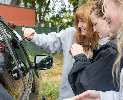 First-year science students dust a car window during their mock crime scene activity