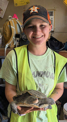 Student poses with turtle