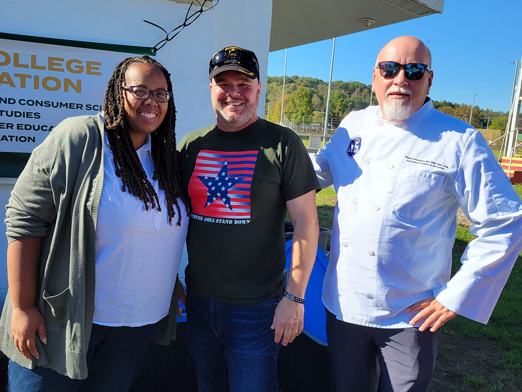 Dean of Patton College Dr. Lisa Harrison, Ohio University’s Veterans and Military Student Services Center Director Terry St. Peter and Associate Professor Thomas Stevenson pose for a photo at Stand Down.