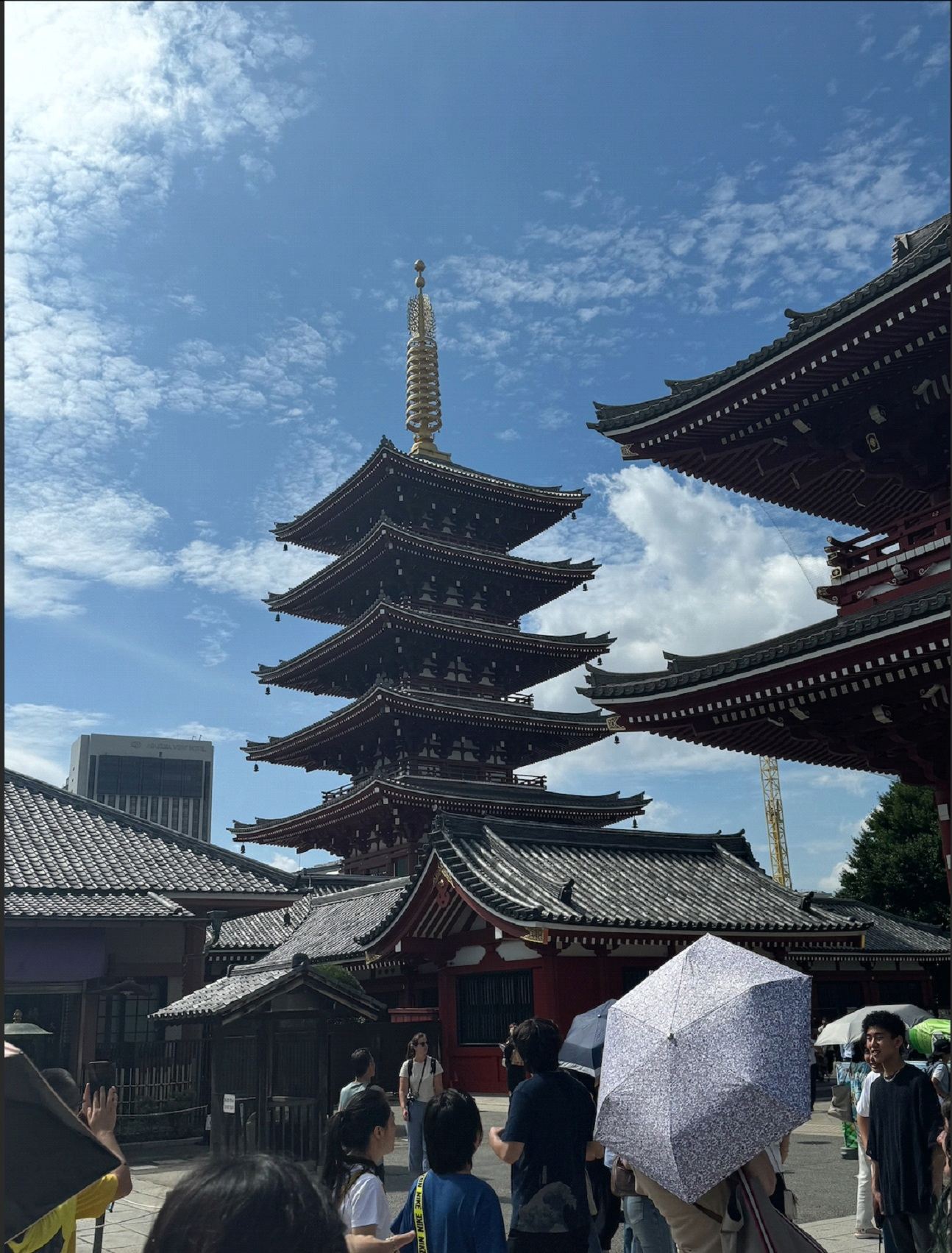 A Japanese-styled tower against a slightly coudy sky. 