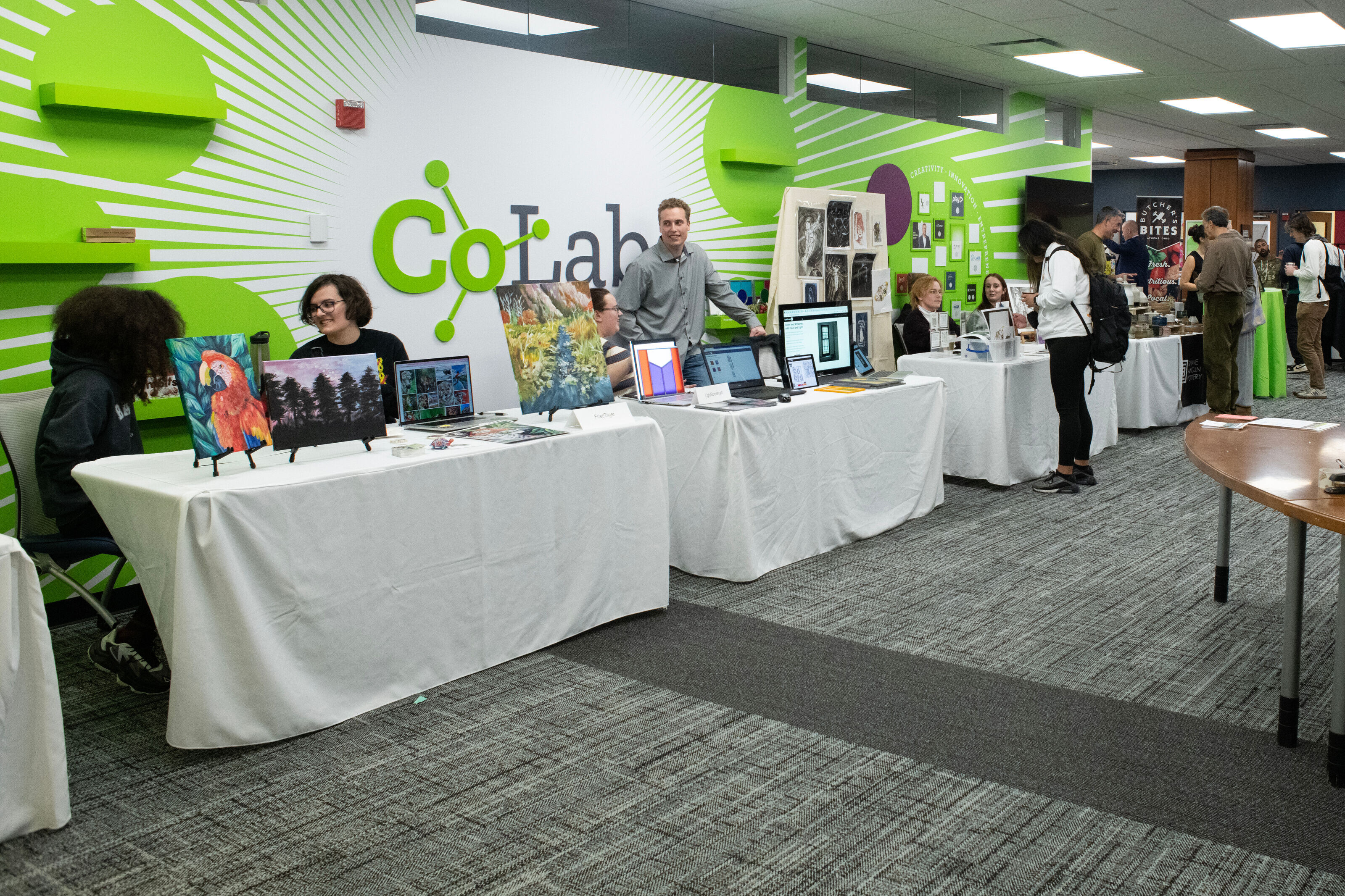 From left to right, various student vendor booths set up in the Ohio University CoLab for the Global Entrepreneurship StartUp Market