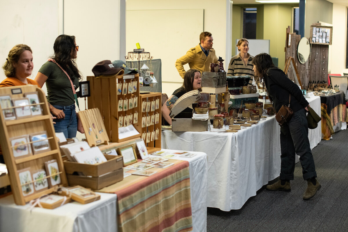 Customers wander from table to table, talking with sellers and looking at their wares at the Global Entrepreneurship Week StartUp Market