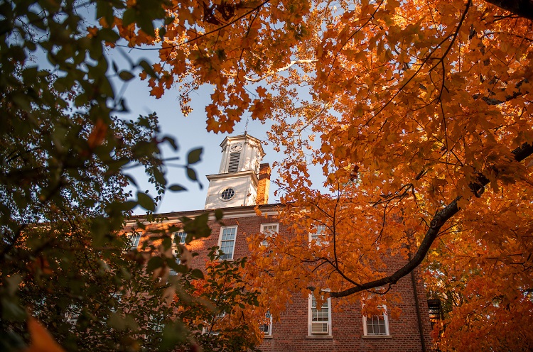 Cutler Hall is surrounded by colorful leaves on a Fall day at Ohio University