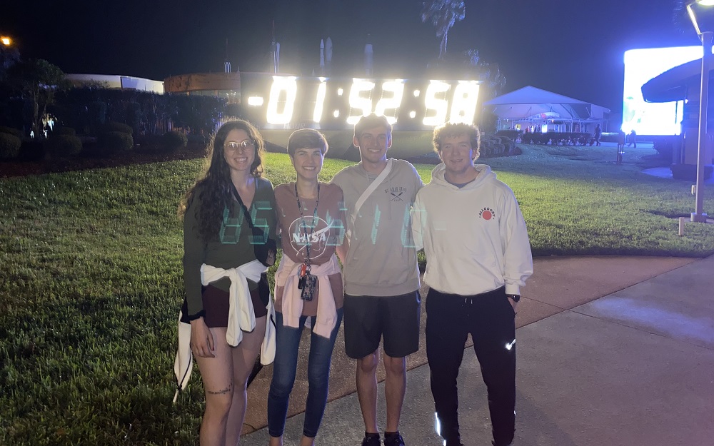 Samantha Fedoush, Victoria Swiler, Nathan Smith, and Michael Lane stand in front of a countdown clock