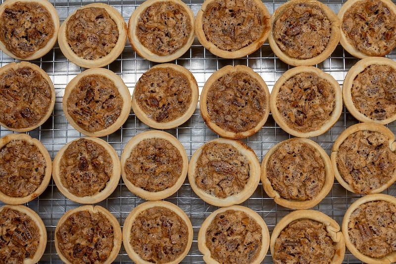 A tray of mini-pecan pies