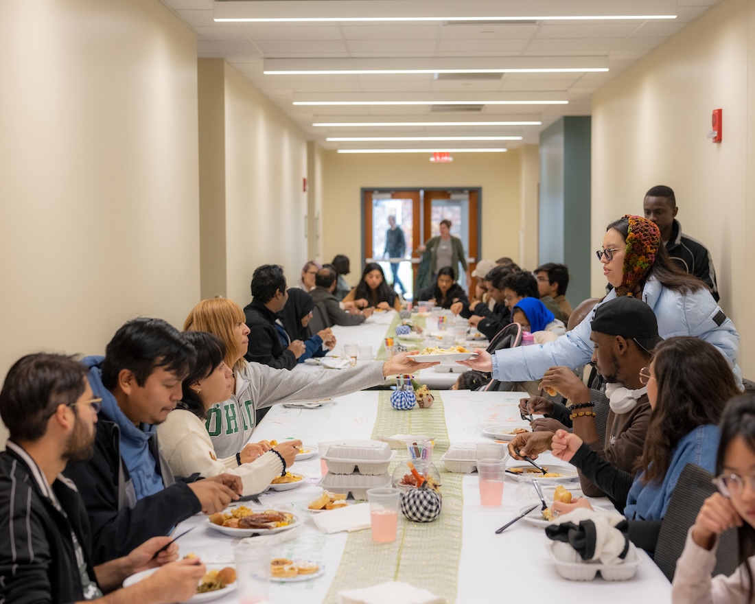 A long table lined with people seated to eat