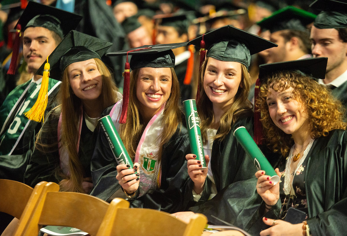 Graduating students show off their diplomas at the Fall 2024 commencement ceremony