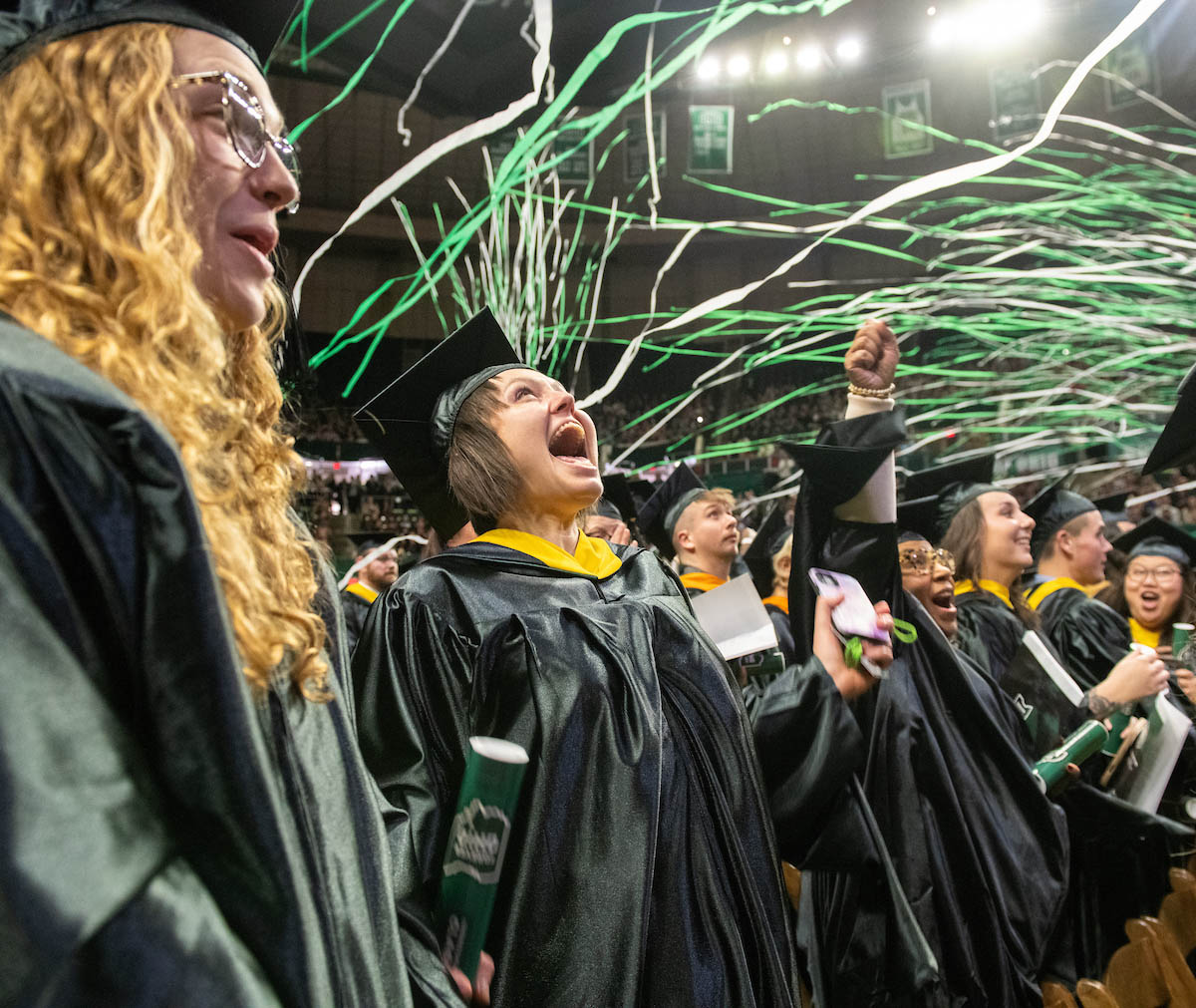 Graduates are surprised by a confetti display at the Fall 2024 commencement ceremony