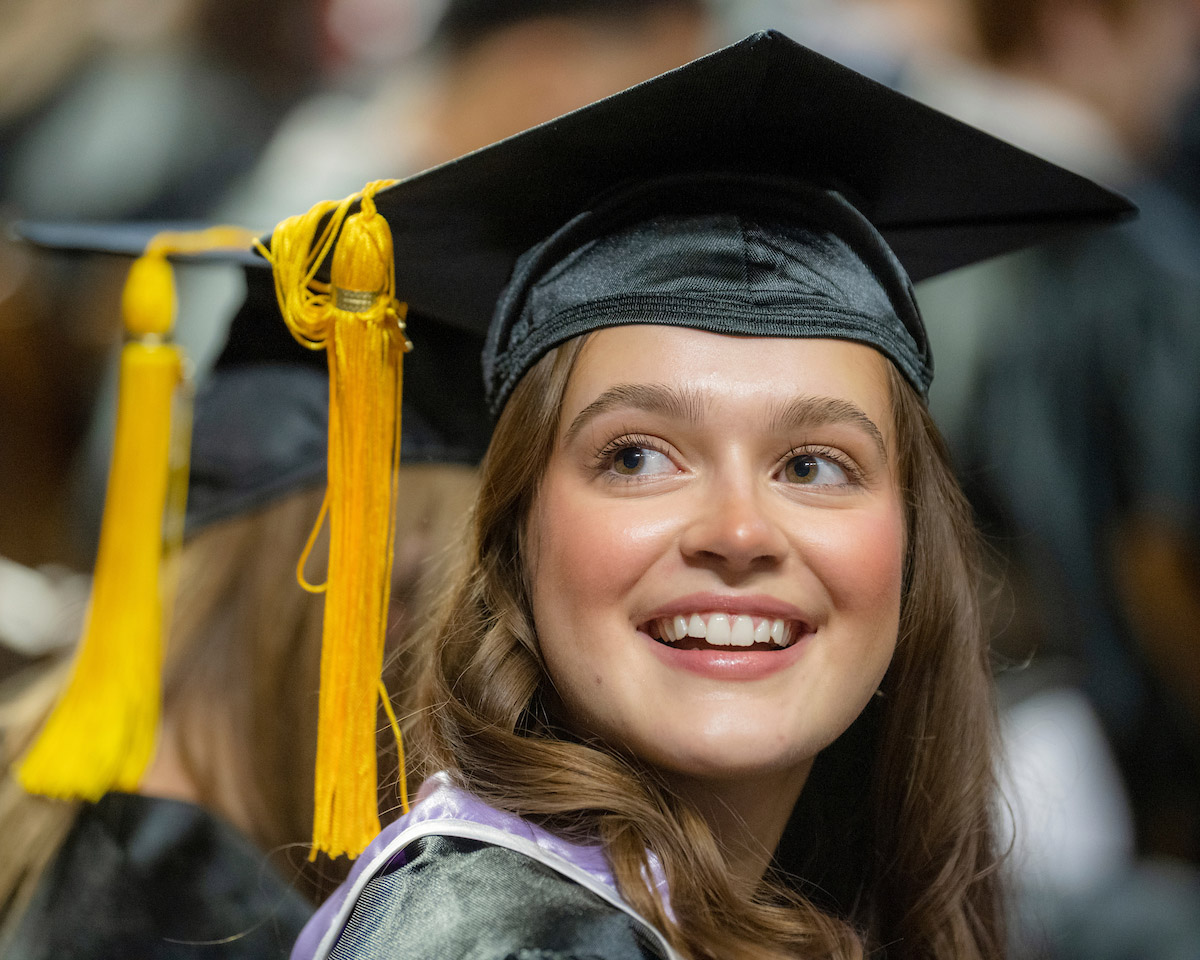 A female graduate at the Fall 2024 commencement ceremony