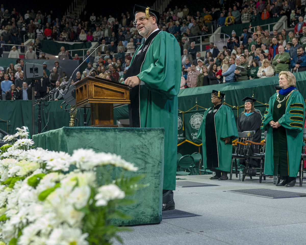 Speaker at the podium during the Fall 2024 commencement ceremony