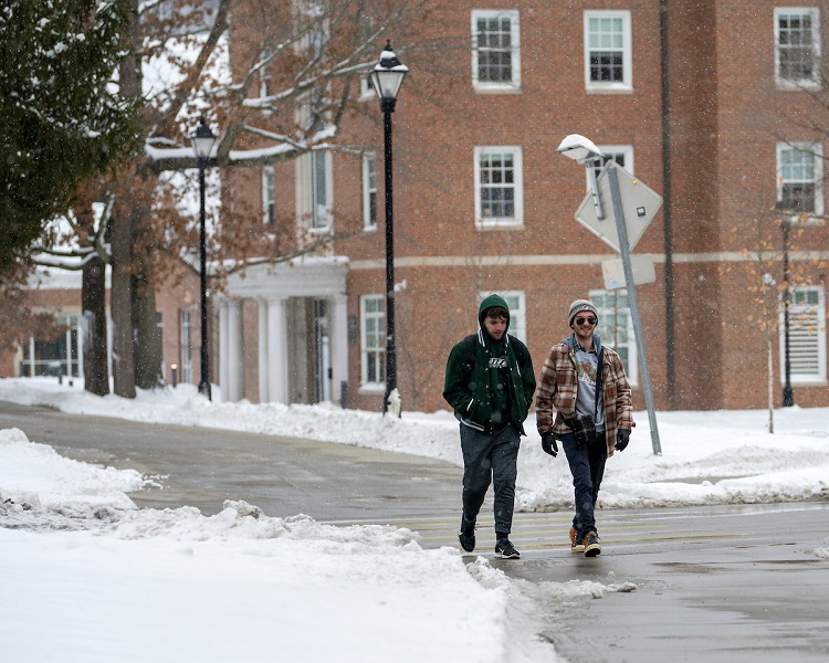 Two individuals walk on the Ohio University Athens Campus on a snowy day in January