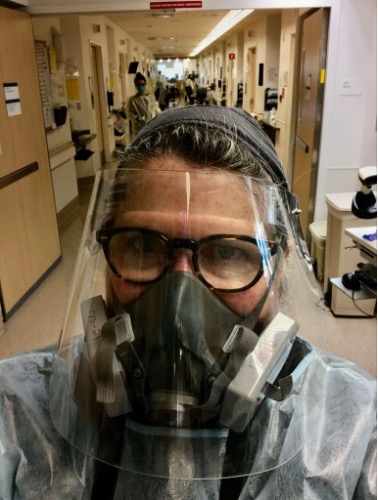 Selfie photo of Francine Orr in a hospital corridor wearing full protective gear during COVID