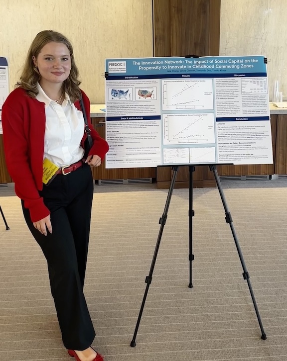 Chloe Christen standing next to her presentation materials 