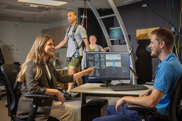 A group of researchers discuss their work at a table. 