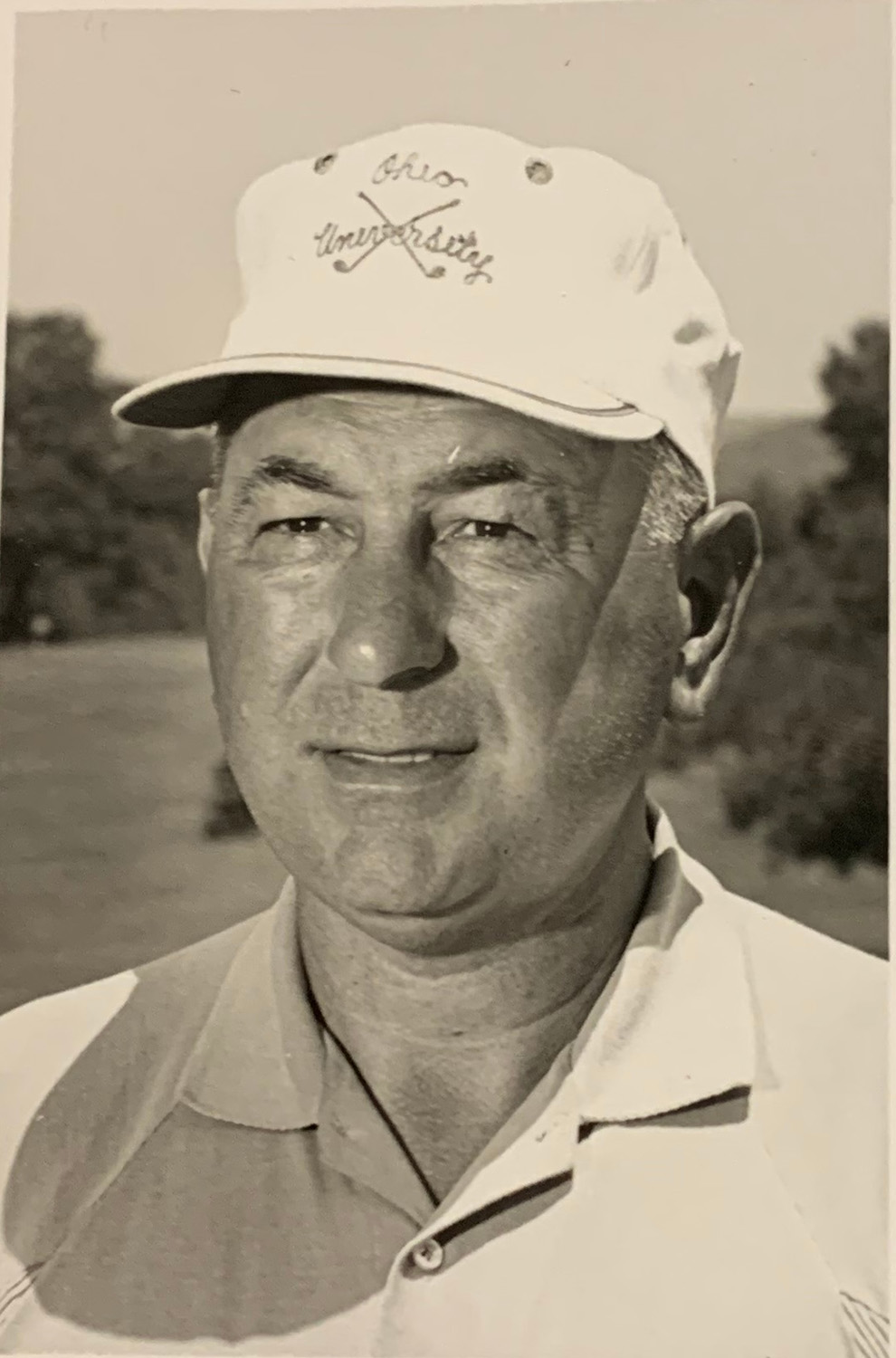 vintage photo of a man in a polo shirt and baseball hat