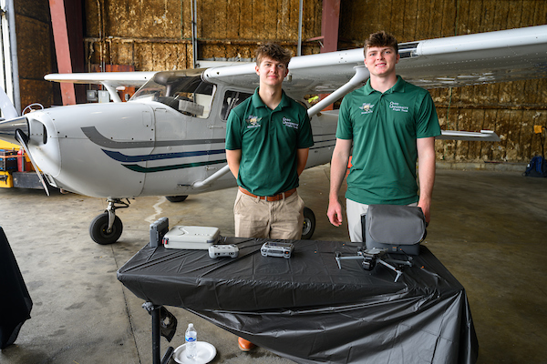 Students in front of plane