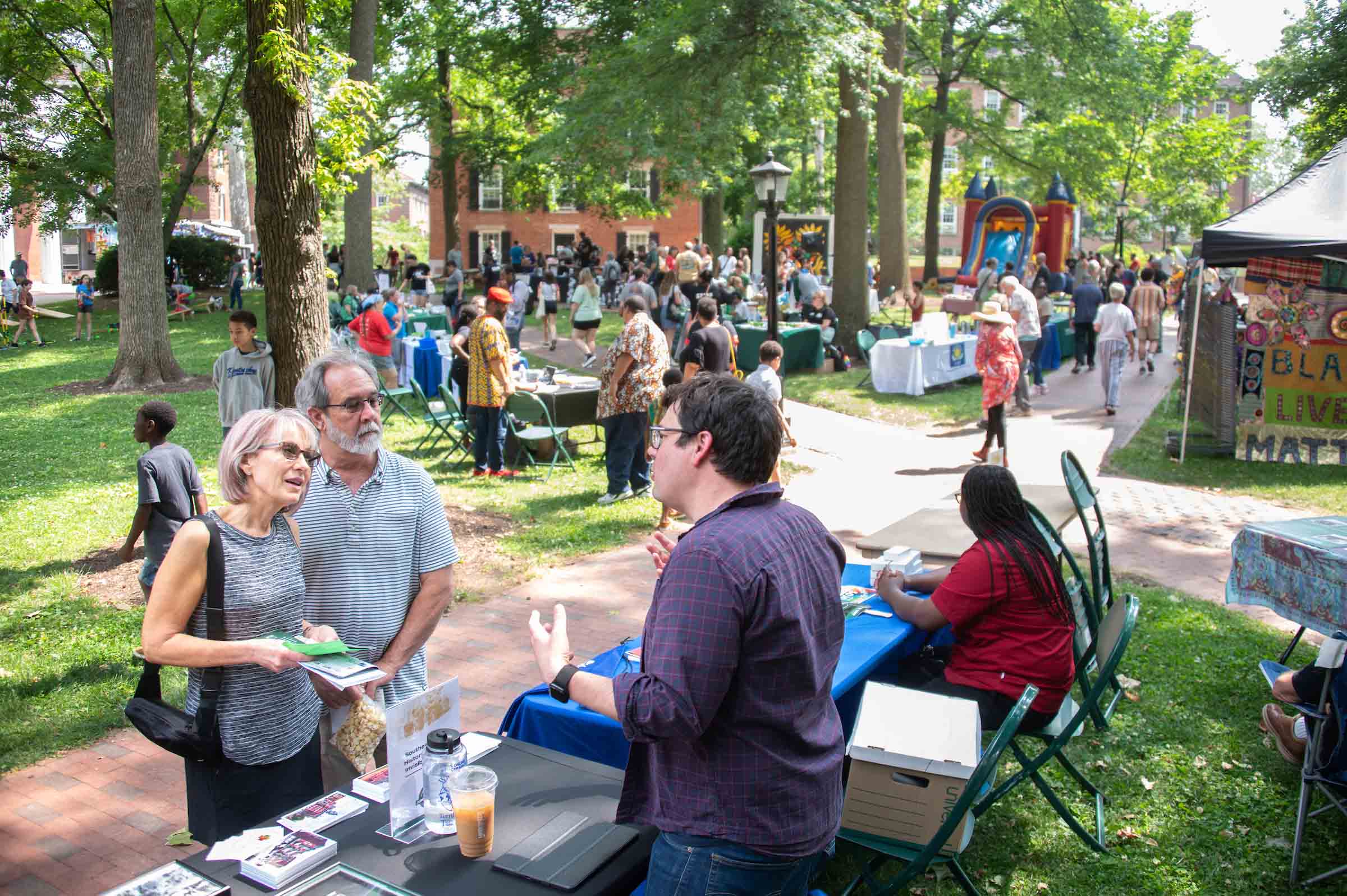 Community members share information about Juneteenth on College Green.