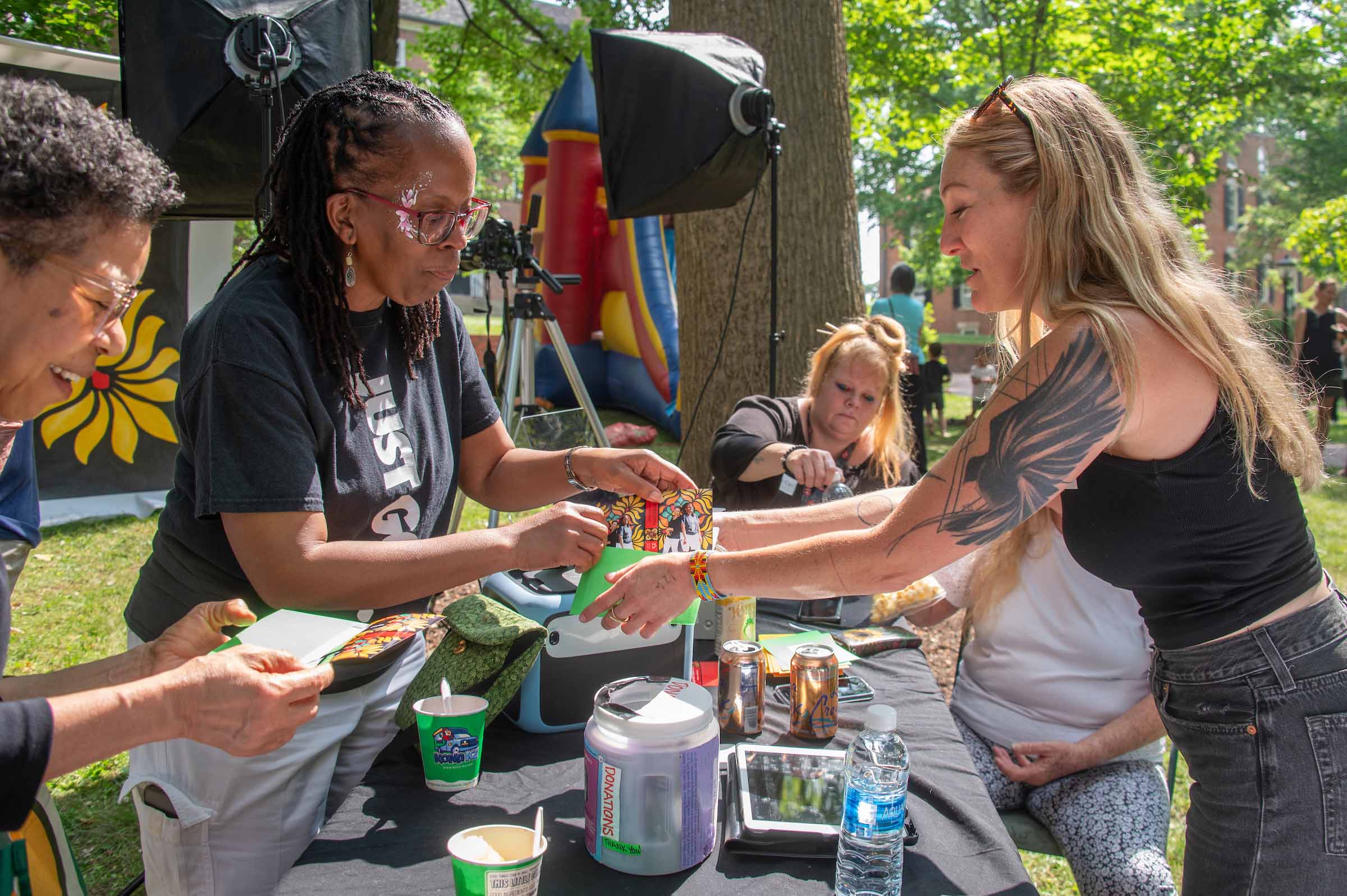 Community members hand out information about Juneteenth on College Green.