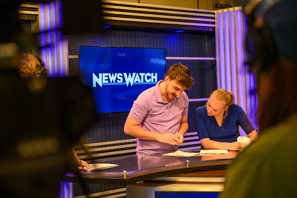 Students collaborate on the set of WOUB's Newswatch program.