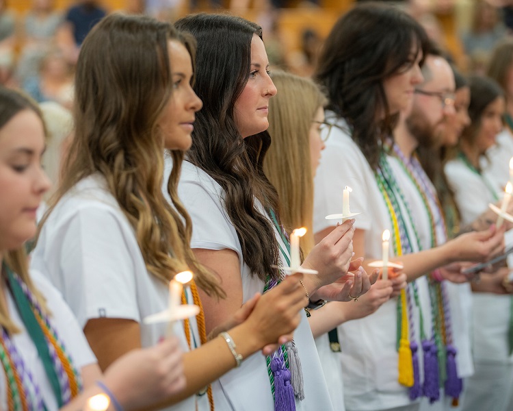 OHIO students hold candles during the OHIO Chillicothe Nurse Pinning Ceremony
