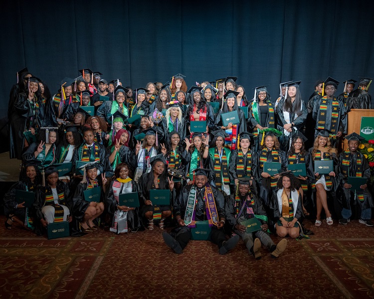 A large group of OHIO graduates pose for a photo