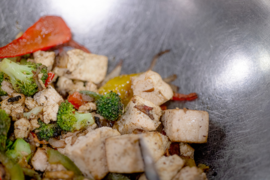 Tofu stir fry with vegetables in a wok at an OHIO dining court.
