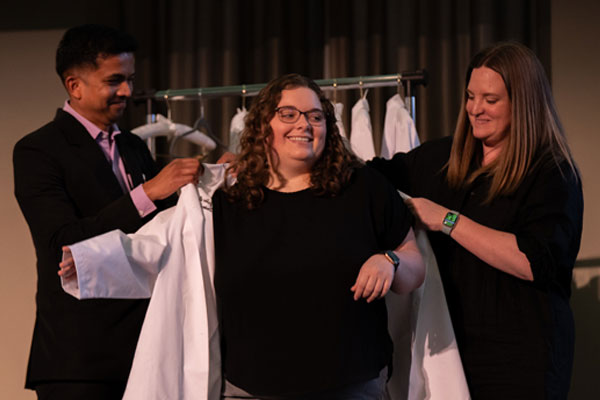 Ohio University audiology doctoral student Julie Boros receiving her white coat