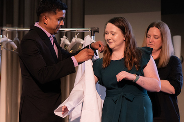 Ohio University audiology doctoral student Morgan Mayor receiving her white coat