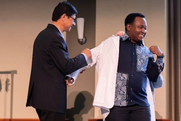 Ohio University audiology doctoral student Nako Mooketsi after receiving their white coat