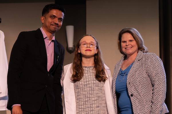 OHIO doctoral audiology student Nicole Egan poses with faculty after receiving her white coat