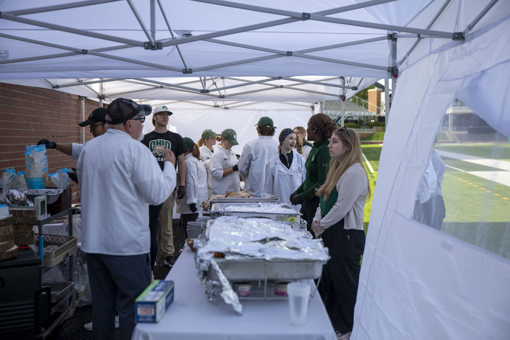 Students and a professor prepare food for the Taste of Brewing event.