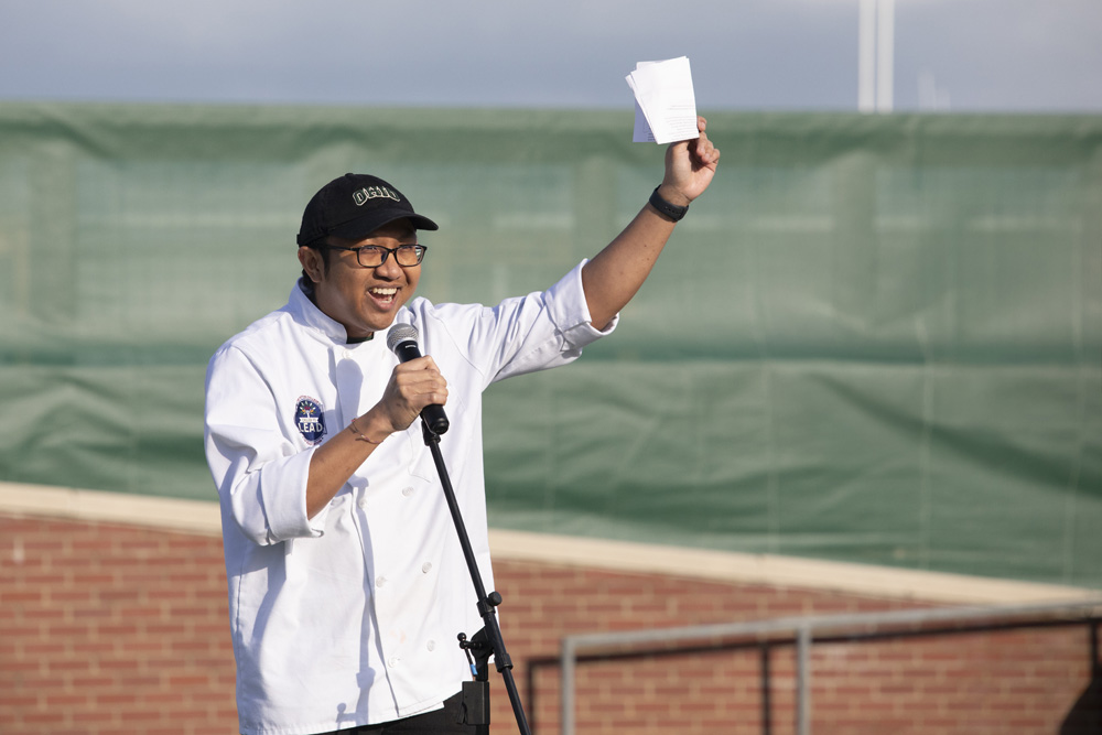 A student talking into a microphone at the Taste of Brewing event.
