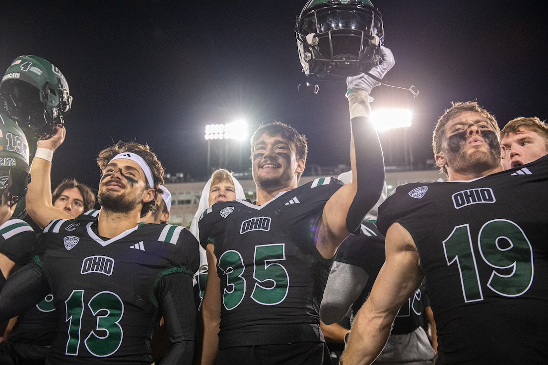Football players holding their helmets