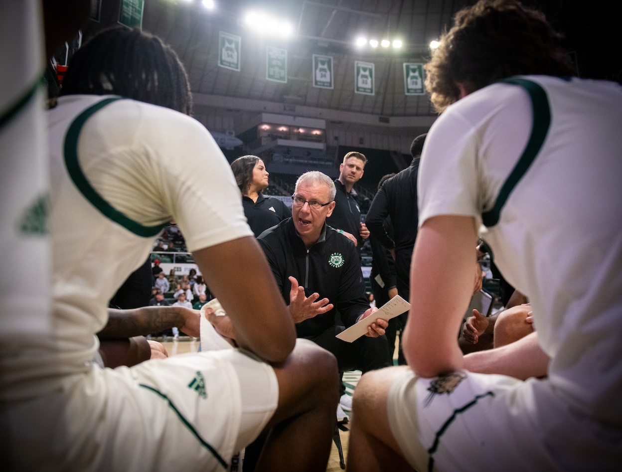 Coach talking with basketball team