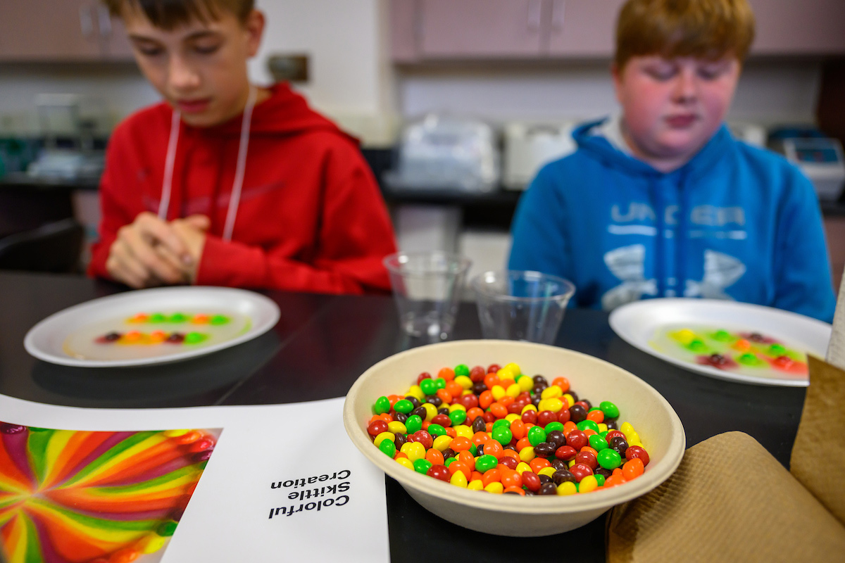 Students watch the colorful effects of diffusion and dissolution during the Skittles STEM activity at Tech Savvy Day 2025.